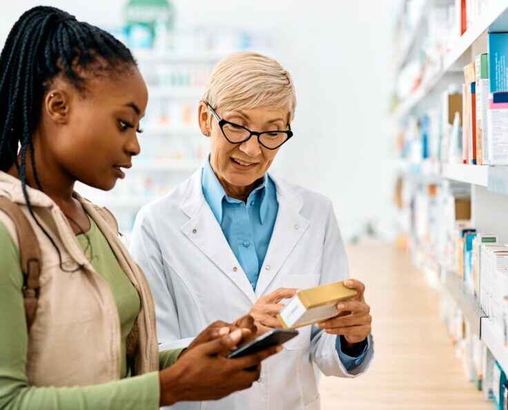 Woman asks a question about a medication to a pharmacist.